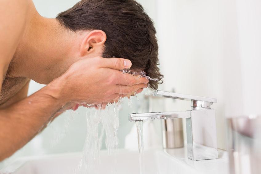 male washing face
