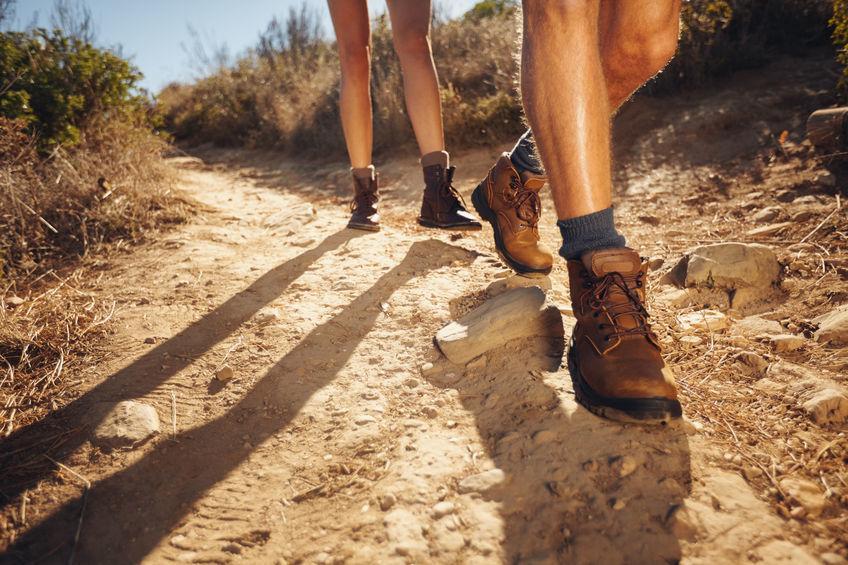 Closeup of a couple's fee hiking on a trail