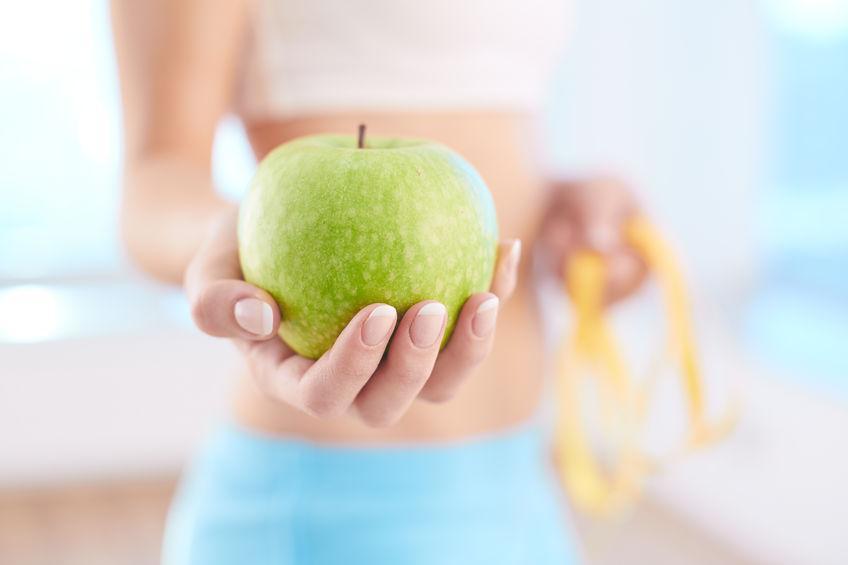 woman holding apple